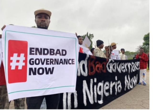 A man hold banner of EndBad Governance Now